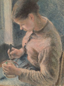 A man is painting with a brush and a cup.