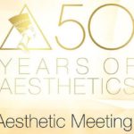 A gold and white logo for the 5 0 th anniversary of aesthetics.